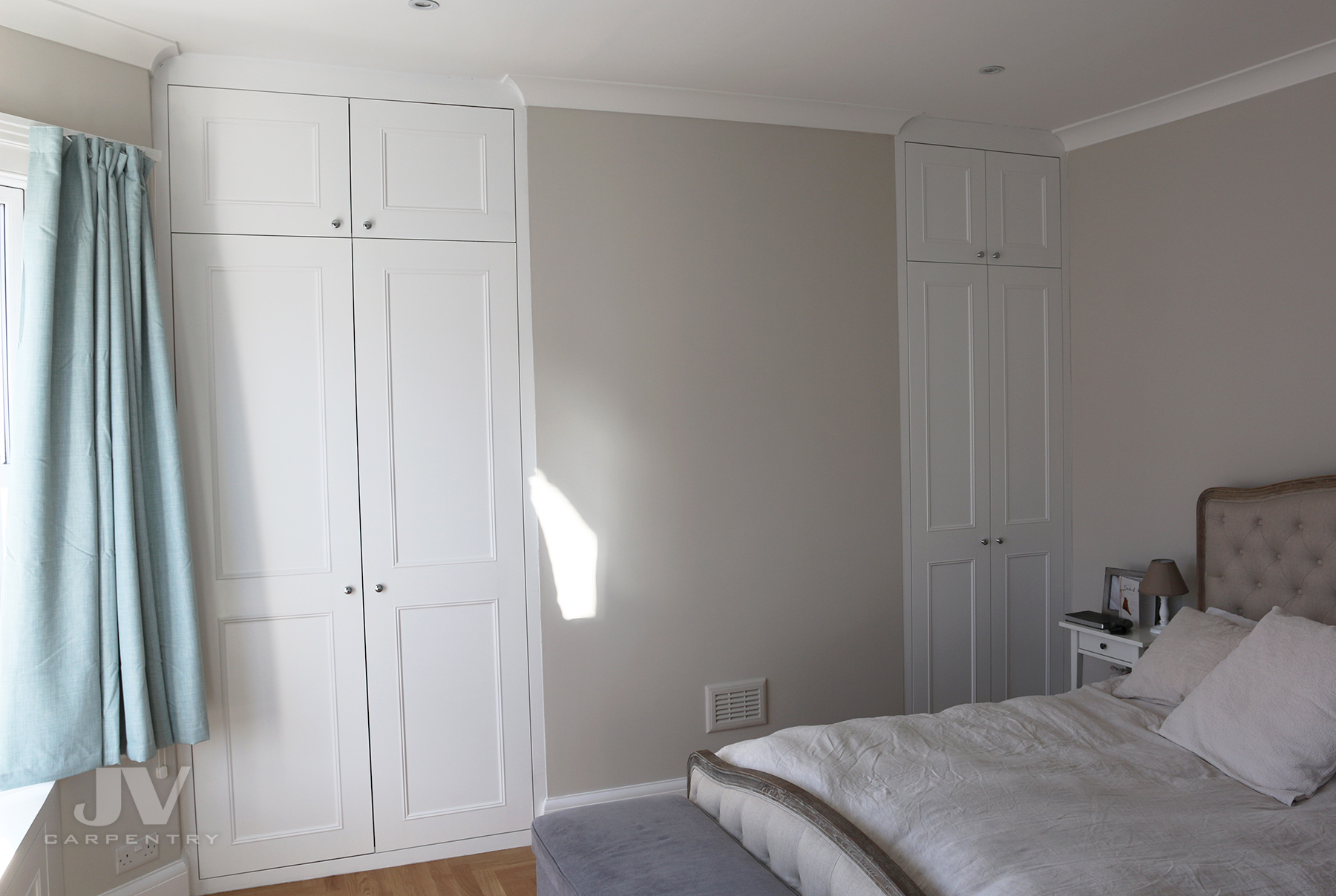 a pair of white alcove fitted wardrobes in West London
